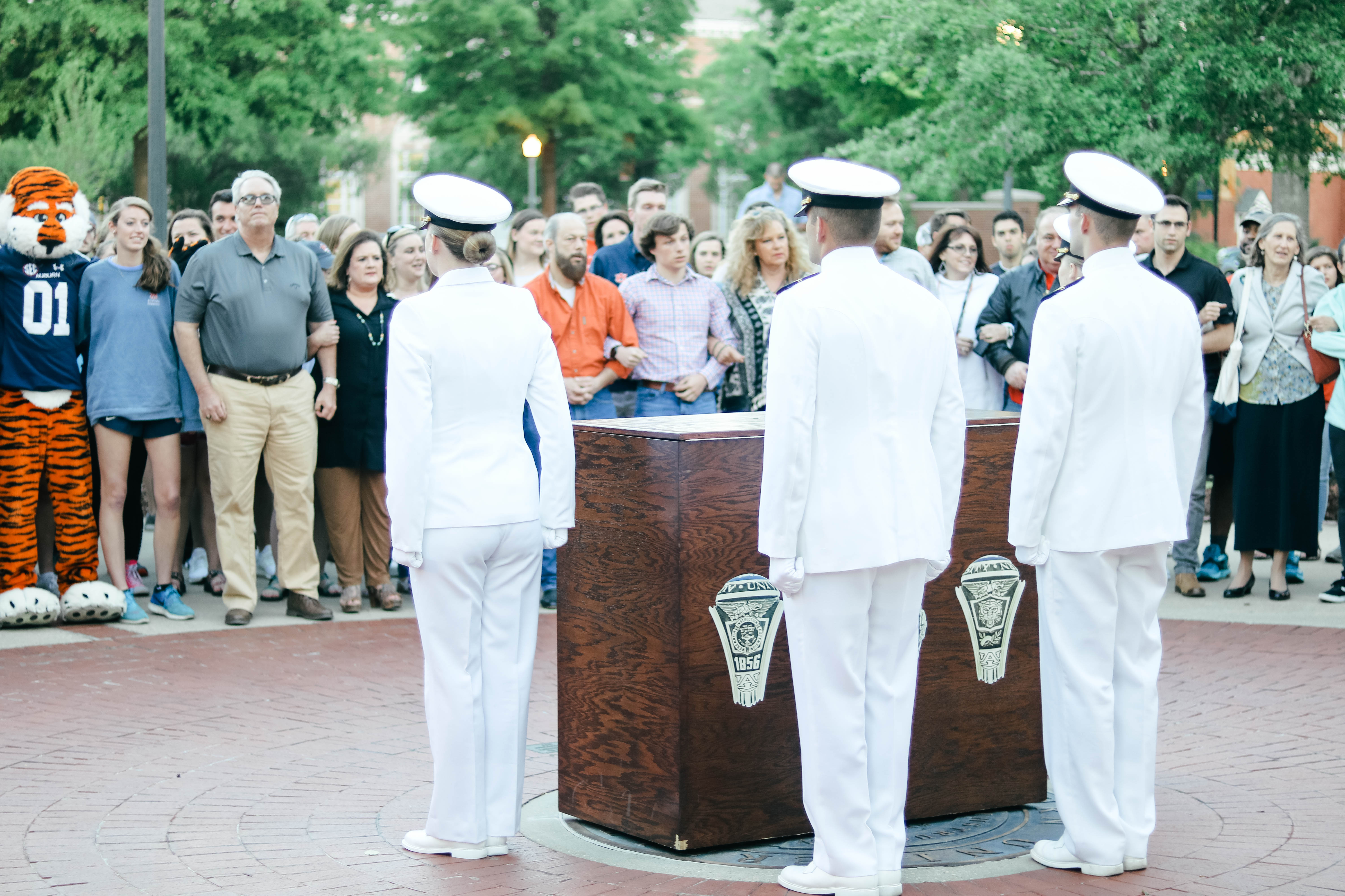 Members of ROTC place the ring box in position over the Auburn Seal at the Ring Night event.