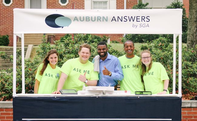 Student Government Association members are in "Ask Me" t-shirts as they work at the Auburn Answers booth during the Auburn Answers event.
